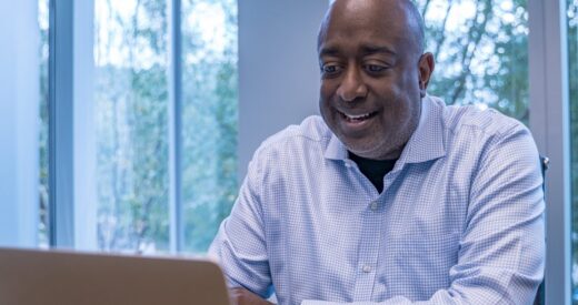 Donald Thompson in a blue shirt at a computer